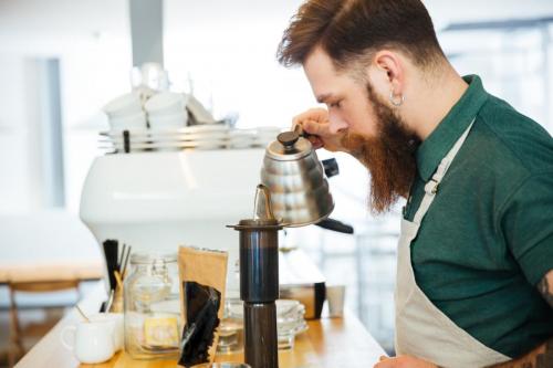 Barista pouring water on coffee ground with filter
