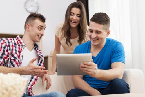 Friends enjoying free wifi on digital tablet