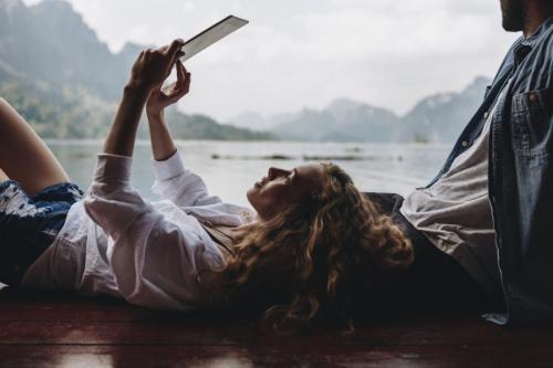 Woman relaxing in her boyfriends lap